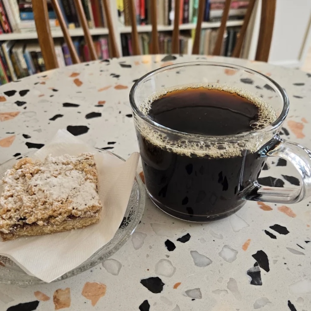 Coffee and toast on a funky patterned table.